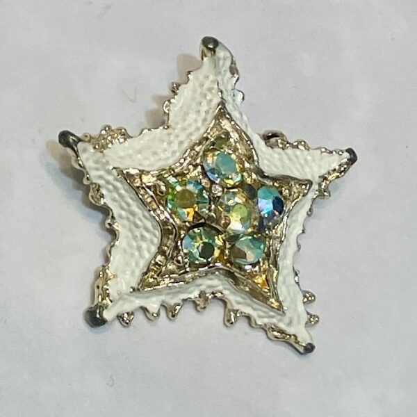 White enamel star brooch with iridescent gems