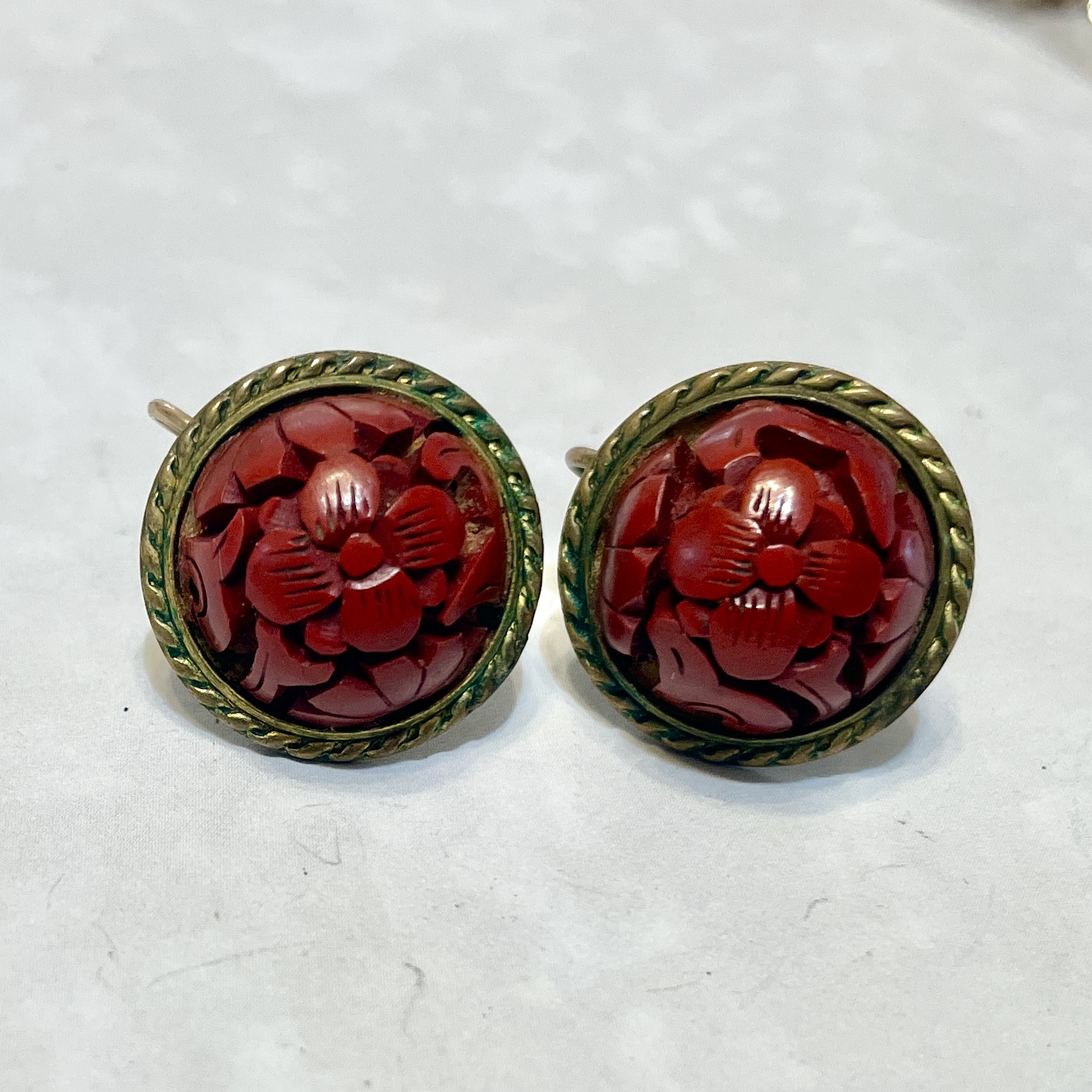 Red carved floral button earrings with brass rim