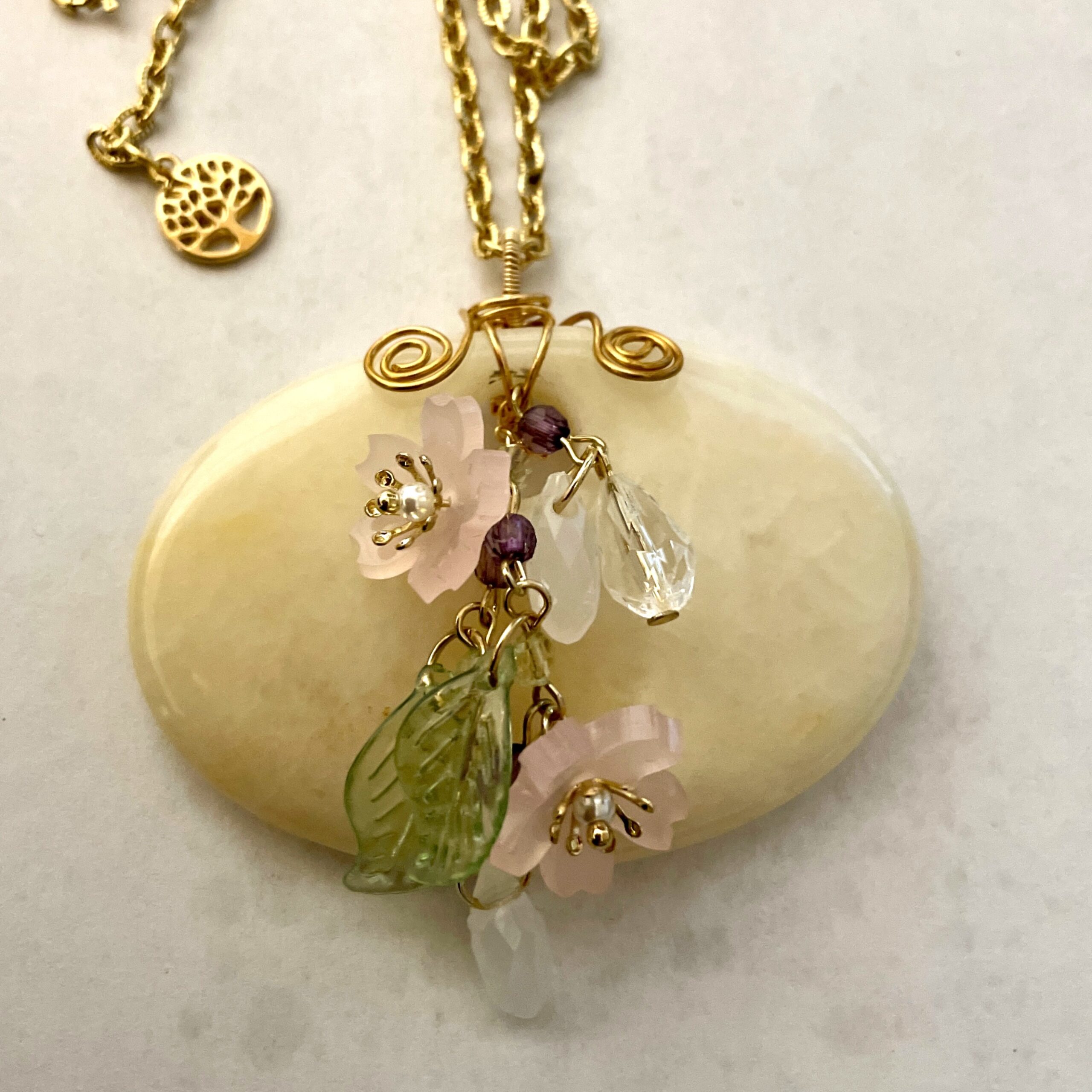 Gold chain necklace with flower and leaf pendant