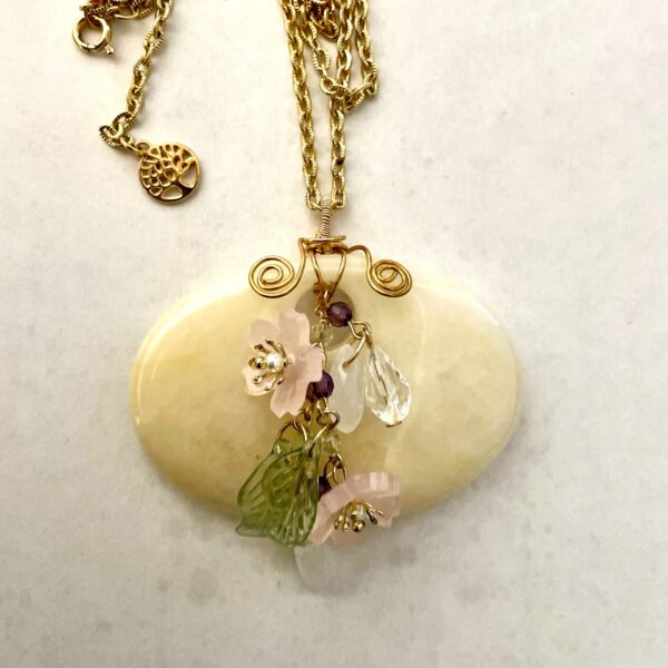 Gold chain necklace with cream heart pendant