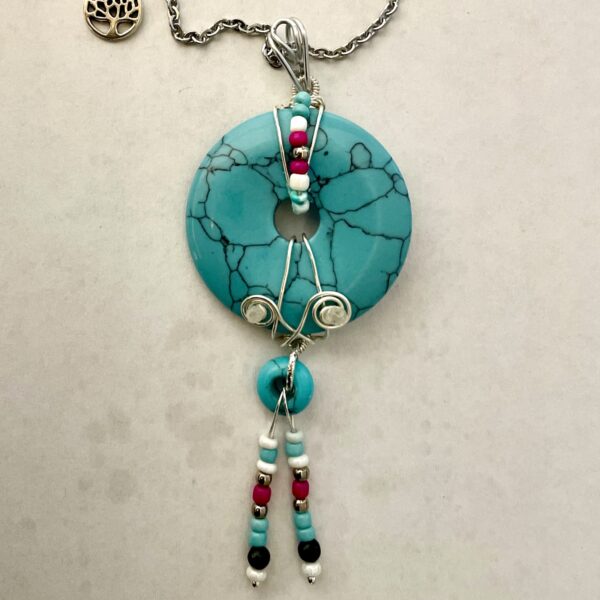 Turquoise donut pendant with beaded tassels