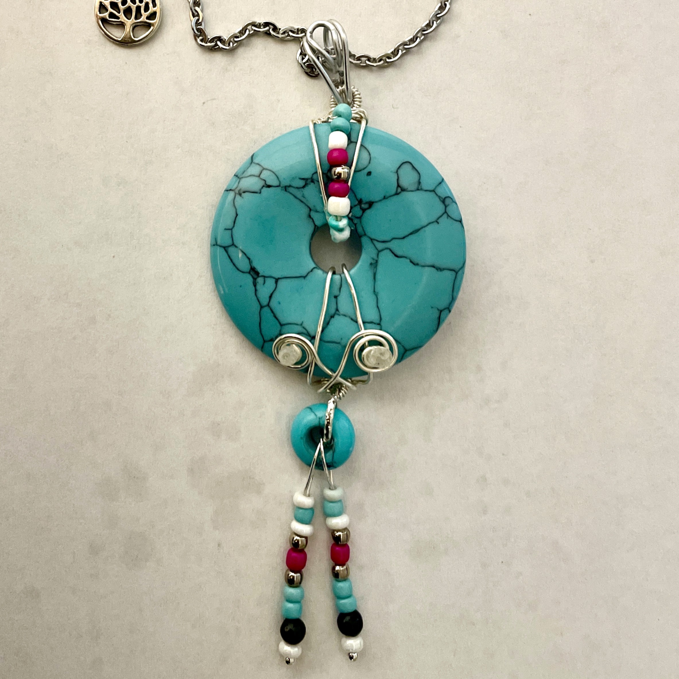 Turquoise donut pendant with beaded tassels