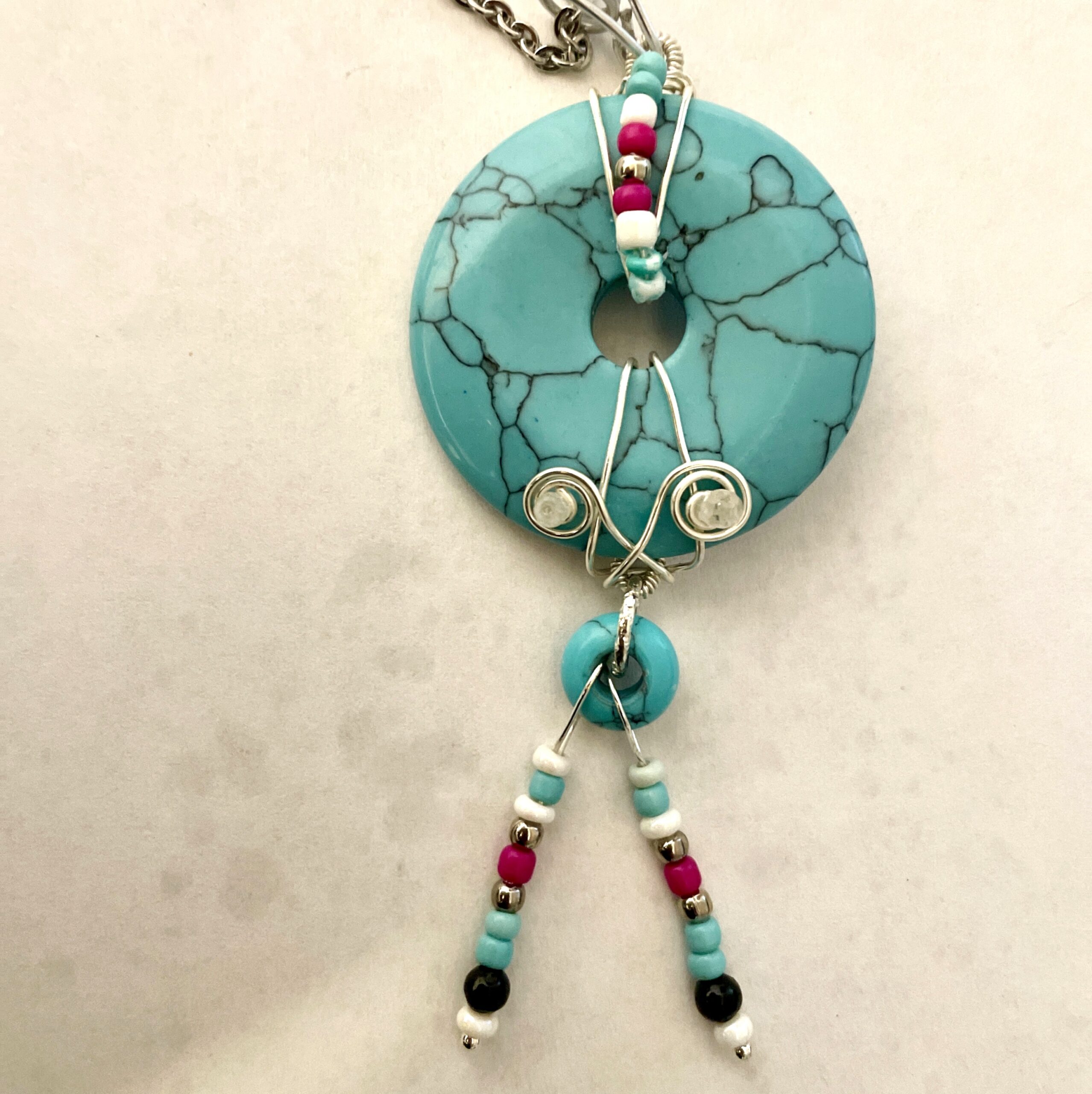 Turquoise donut pendant necklace with beaded tassels