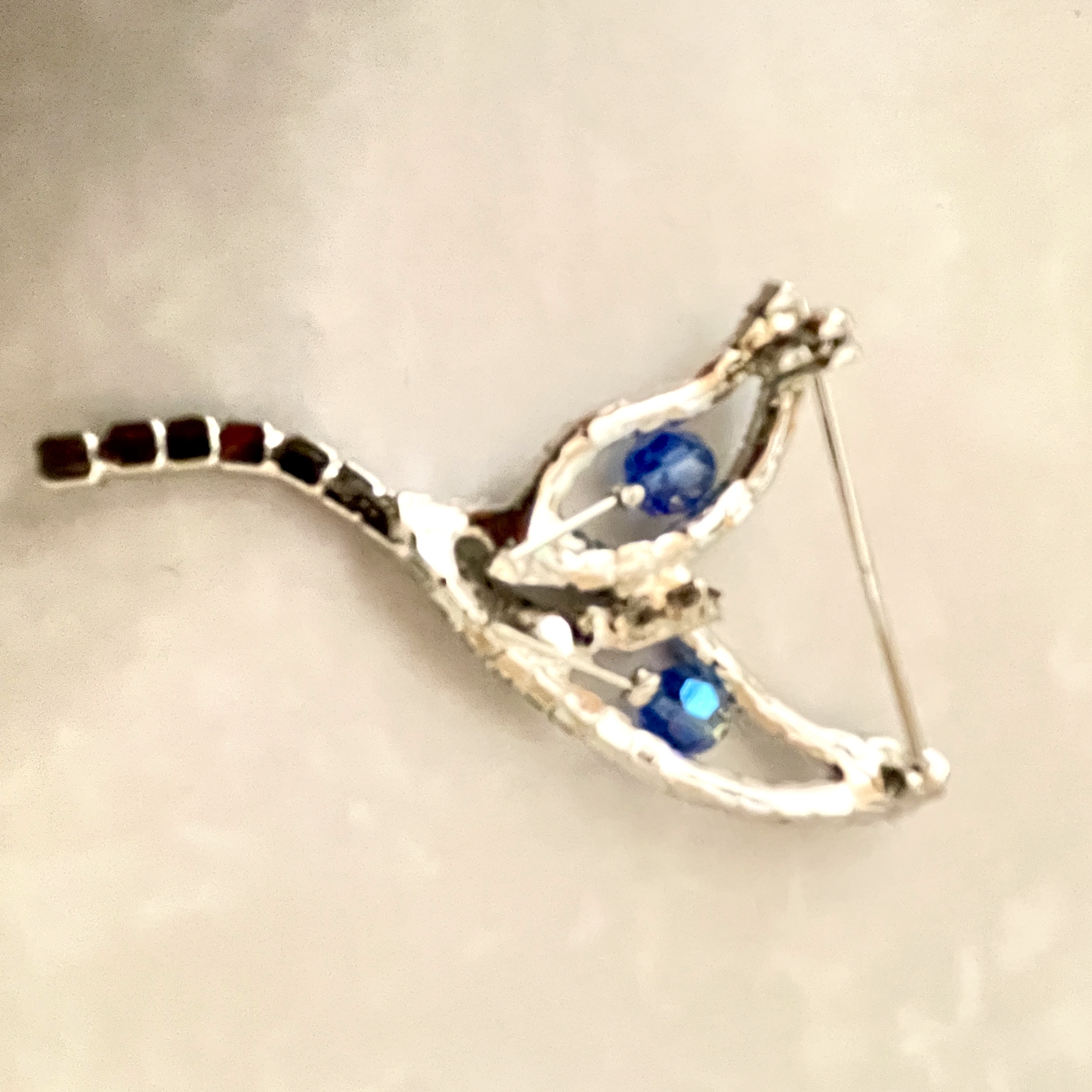 silver leaf brooch with blue gemstones