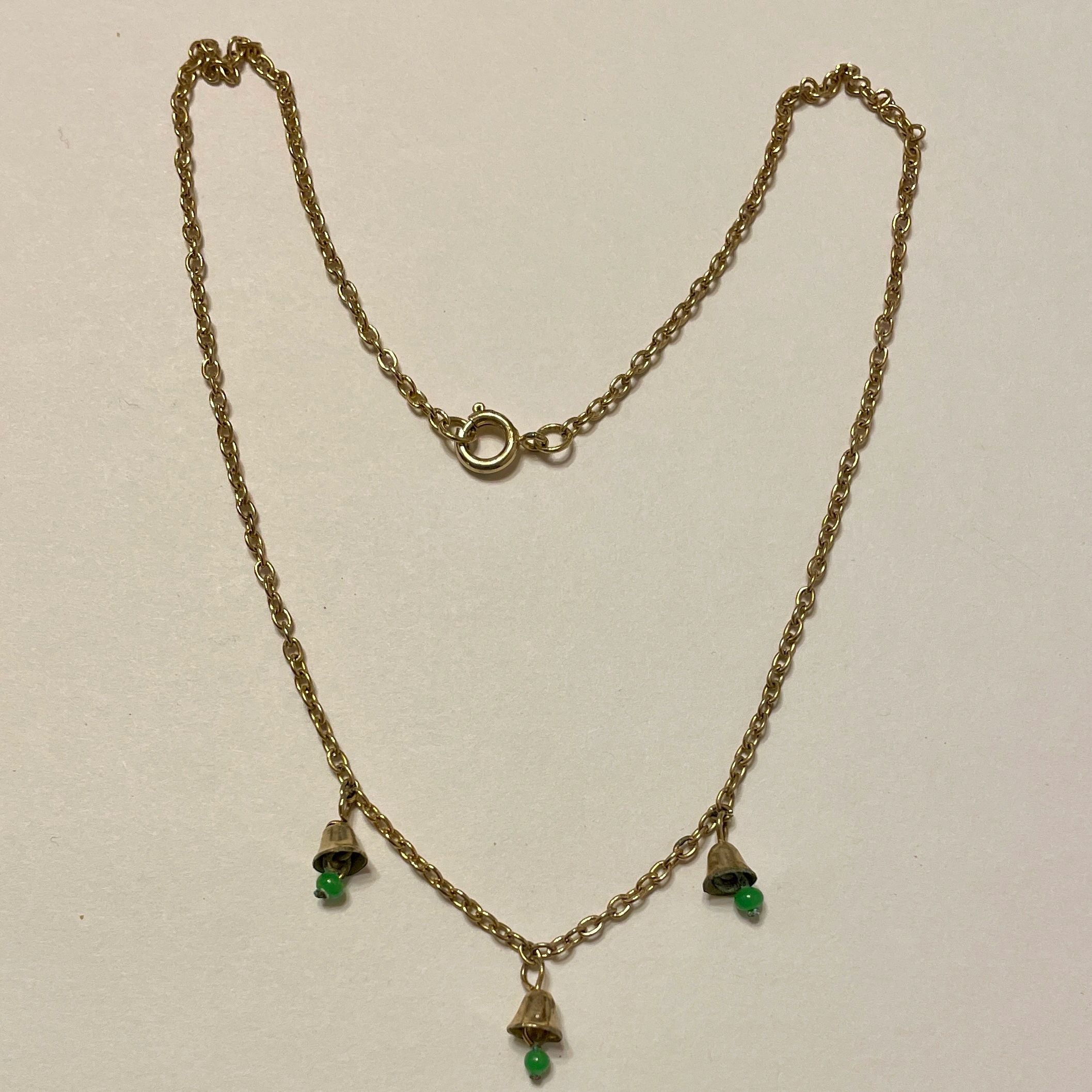 Gold chain necklace with three green-beaded bells