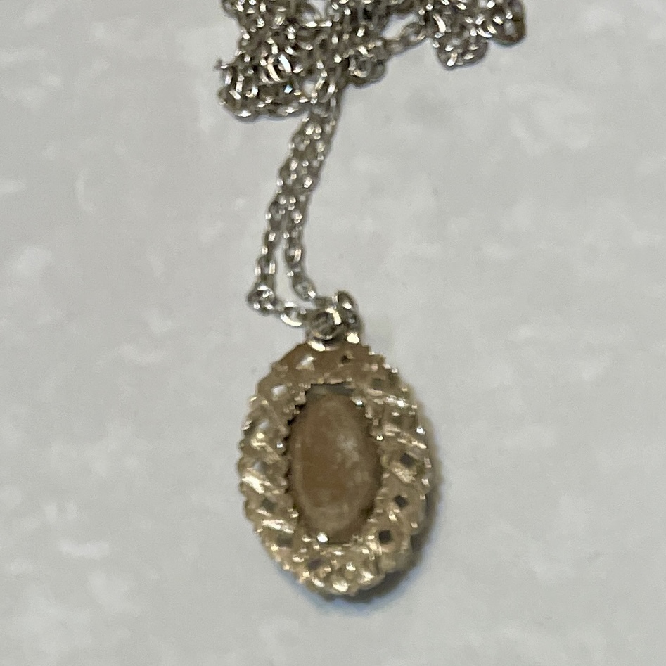 Oval gold pendant necklace with brown stone
