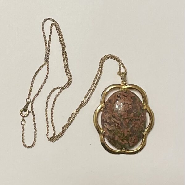 Gold chain necklace with oval stone pendant