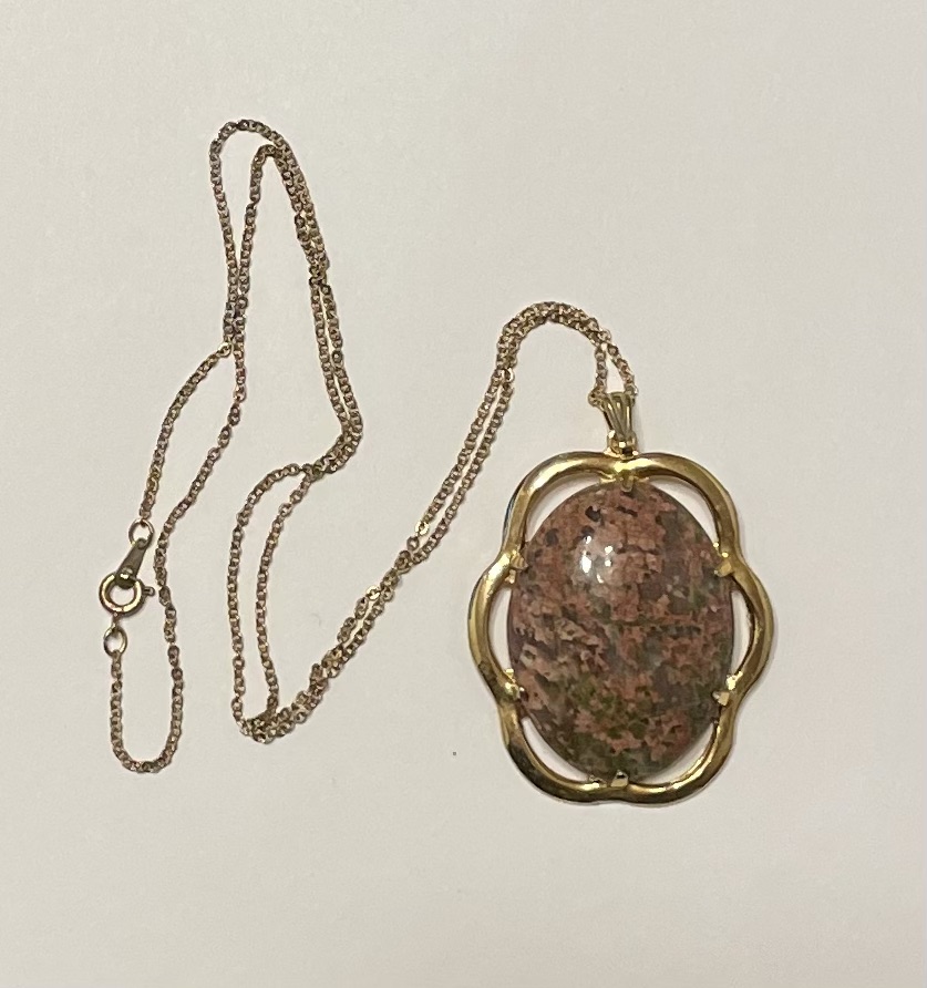 Gold chain necklace with oval stone pendant