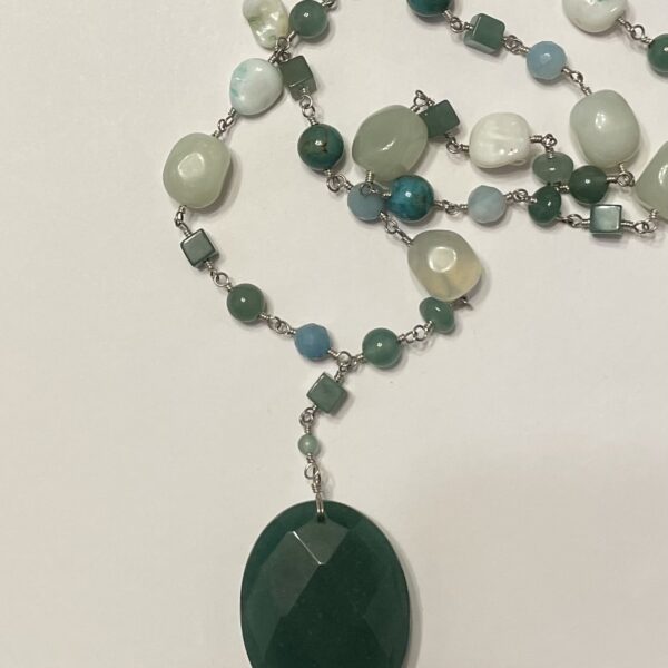 Green beaded necklace with faceted oval pendant