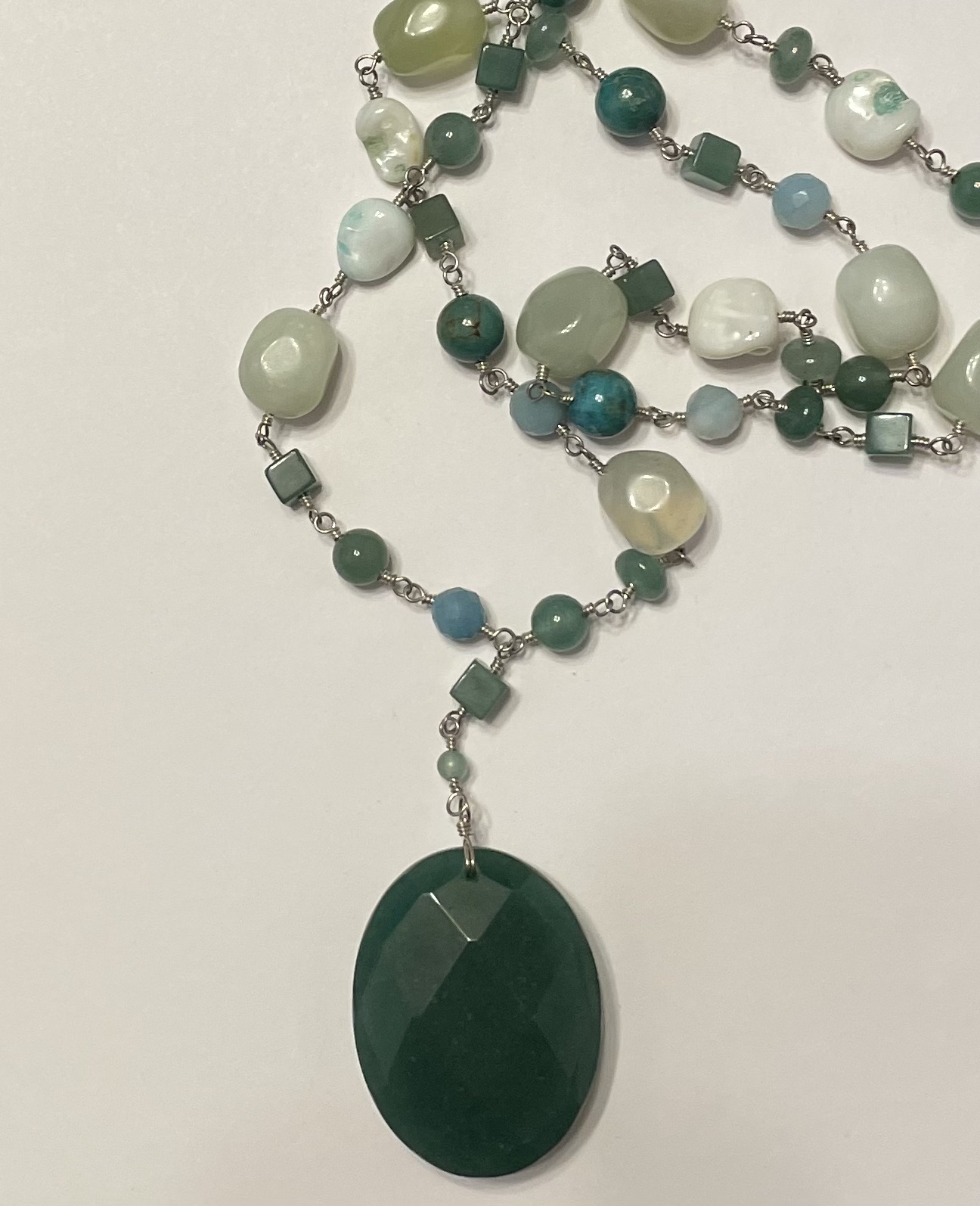 Green beaded necklace with faceted oval pendant