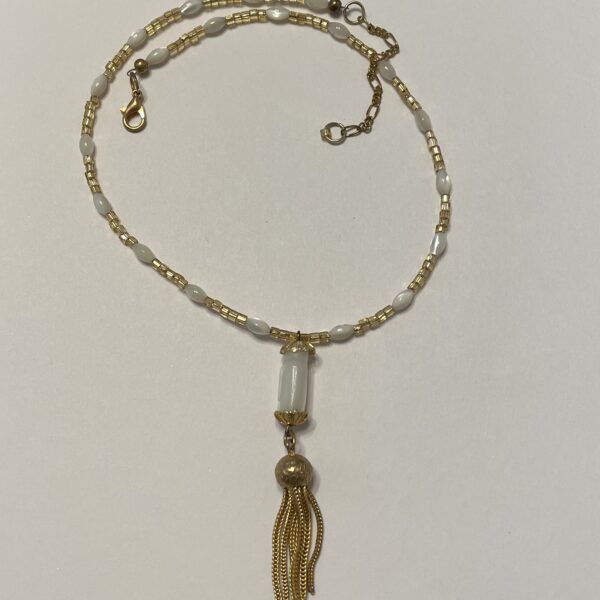 Gold and white beaded necklace with tassel