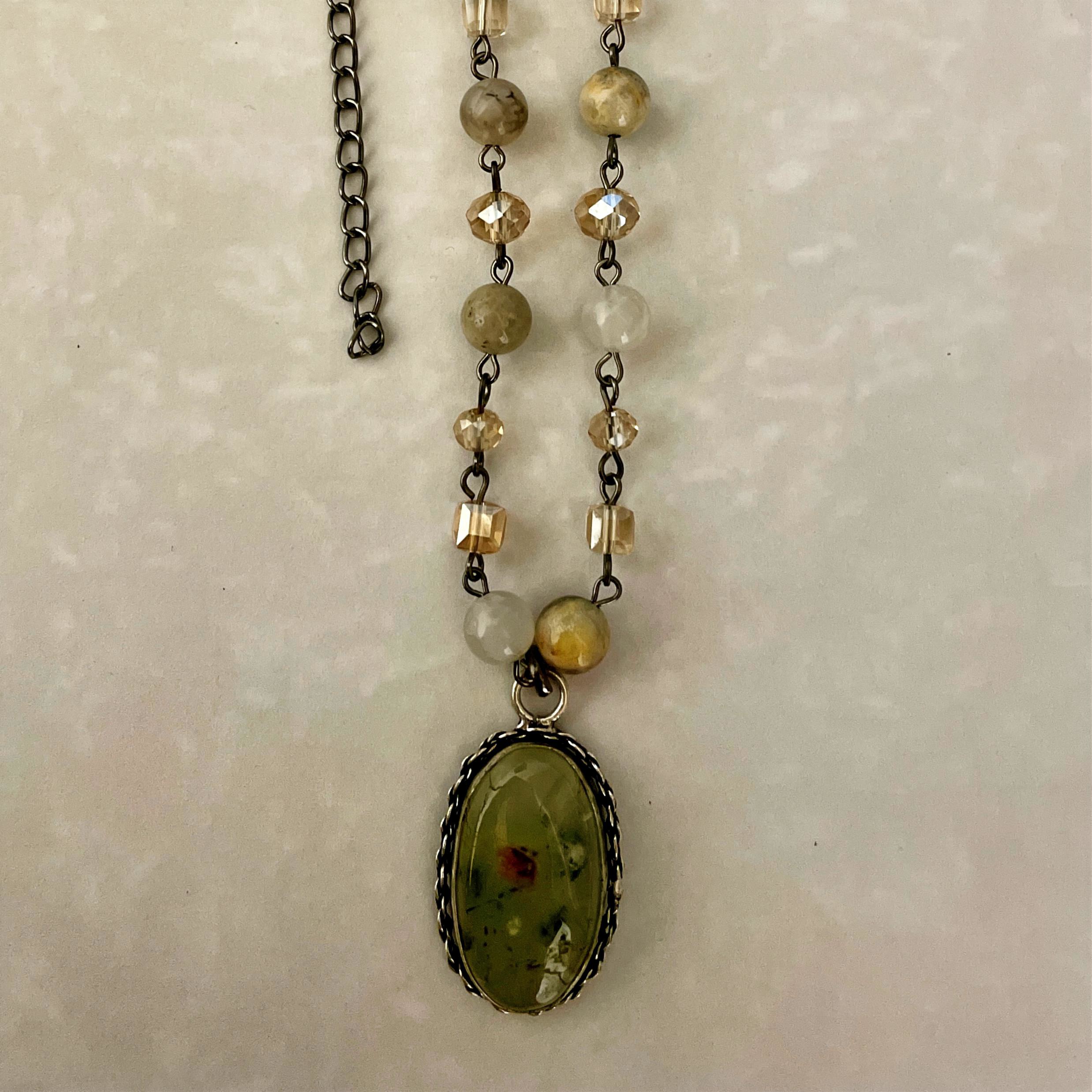 Green oval stone pendant on beaded chain