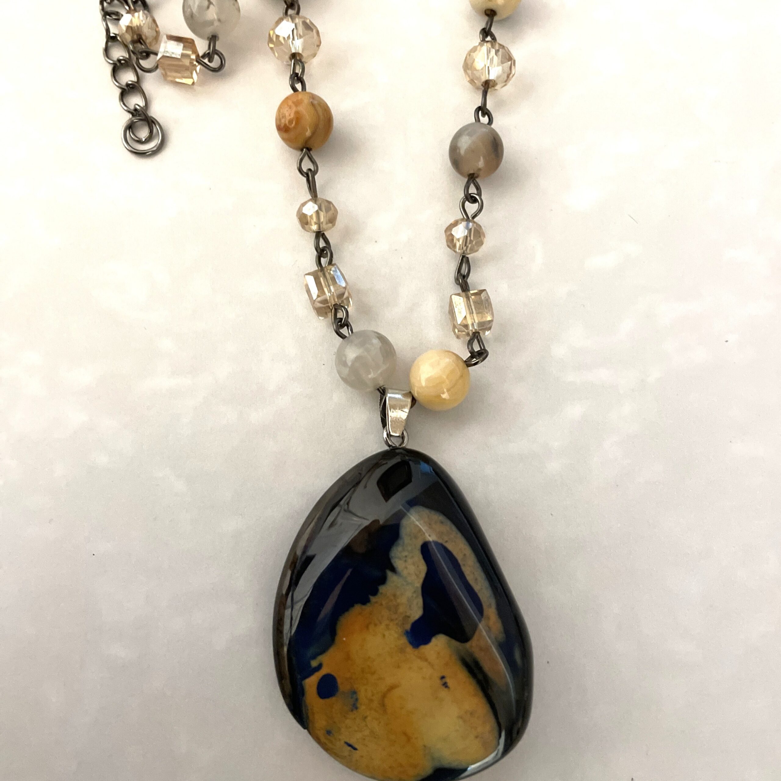 Glossy blue and yellow stone pendant necklace