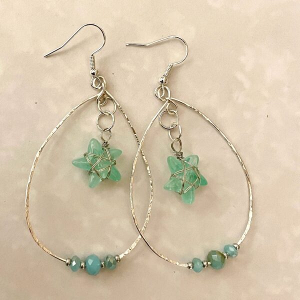 Silver hoop earrings with green star charms
