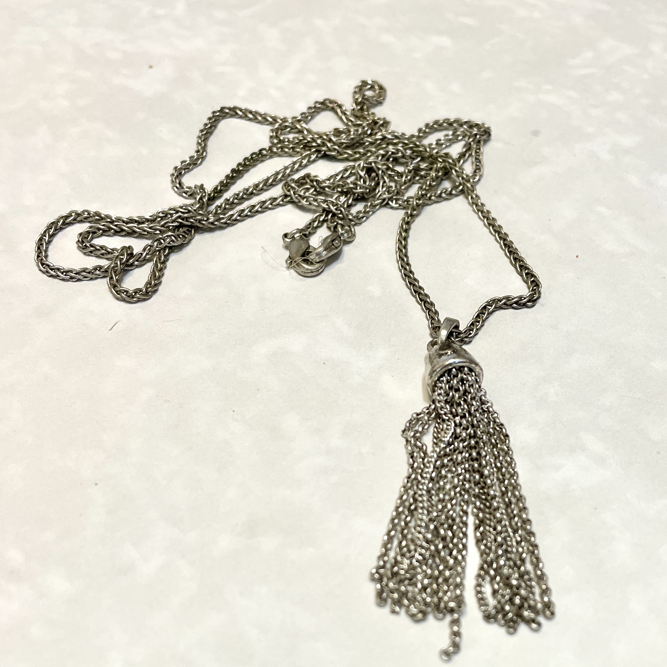 Elegant silver necklace with tassel charm