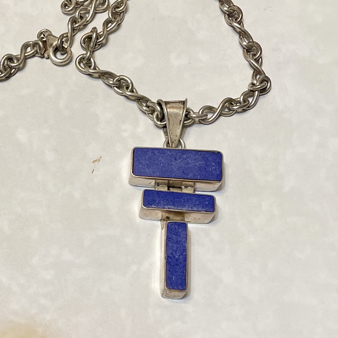 Stylish silver necklace with blue pendant
