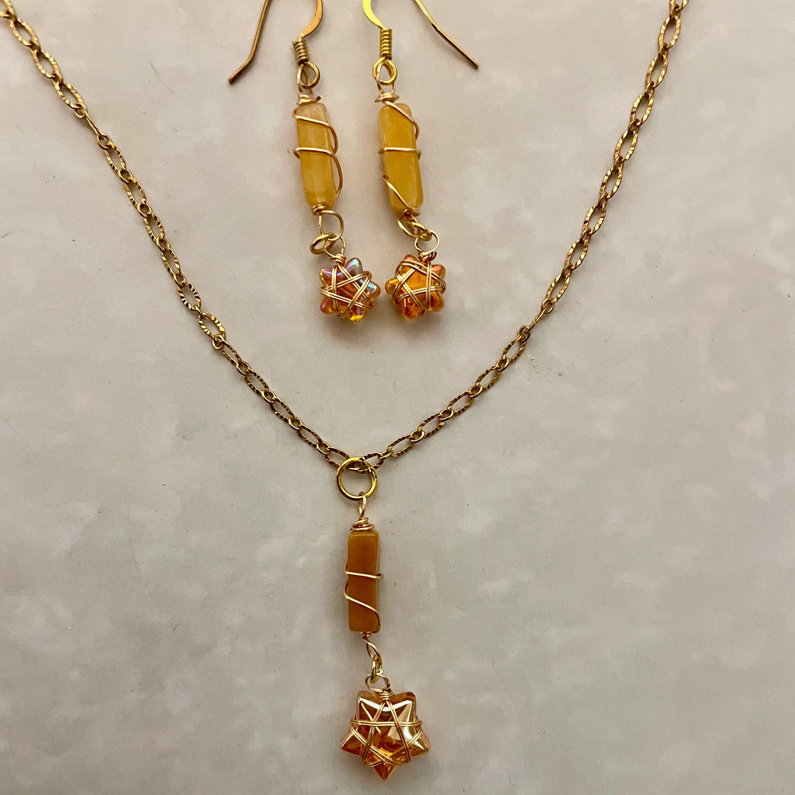 Gold necklace with wire-wrapped pendant and earrings
