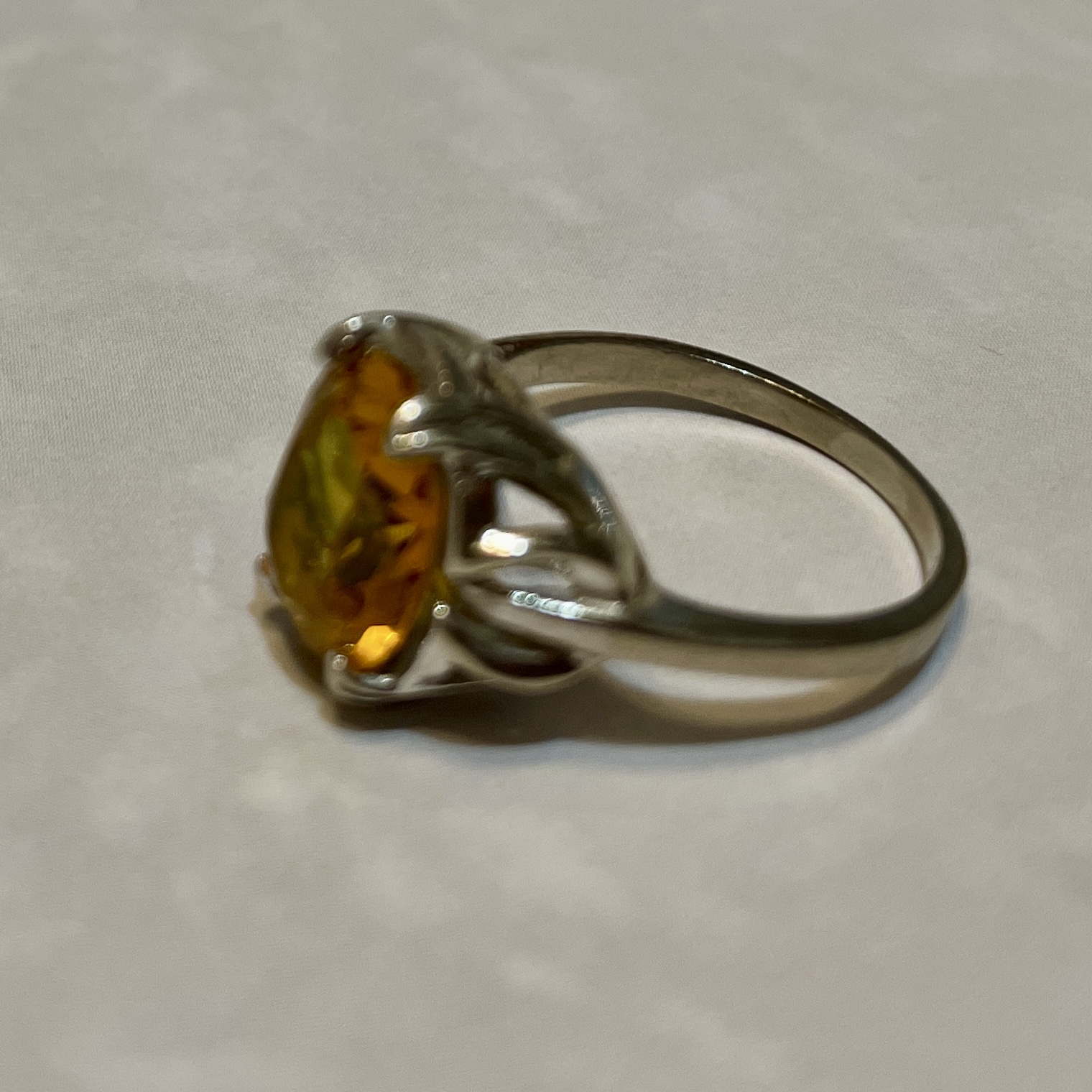 Elegant ring featuring a vibrant yellow gemstone.