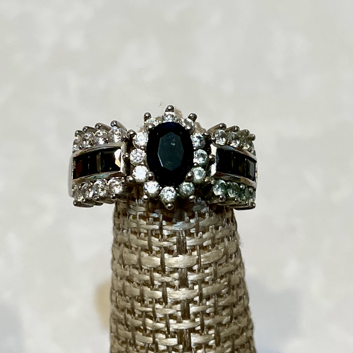 Elegant ring featuring a dark central gemstone.