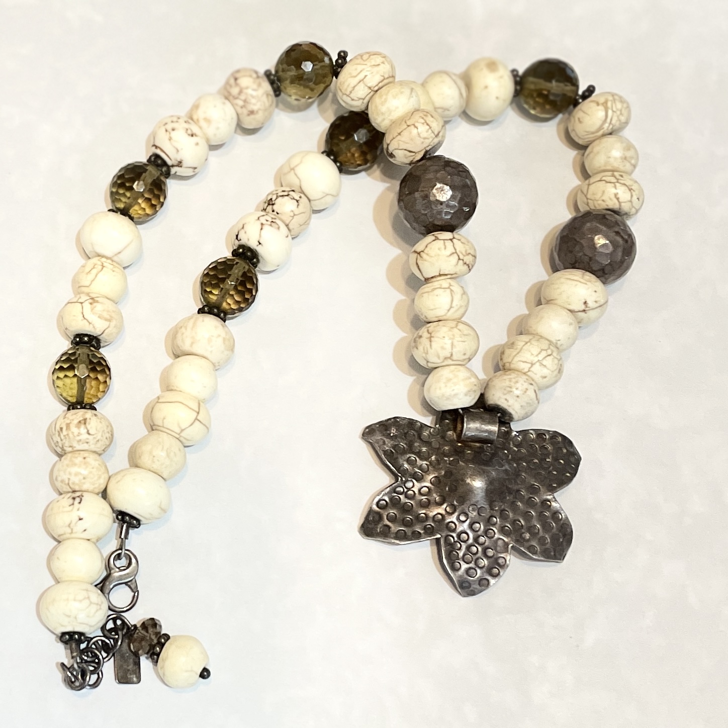White and brown beaded necklace with flower pendant