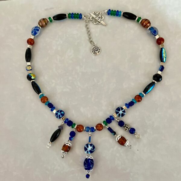 Beaded blue-brown necklace with dangling charms