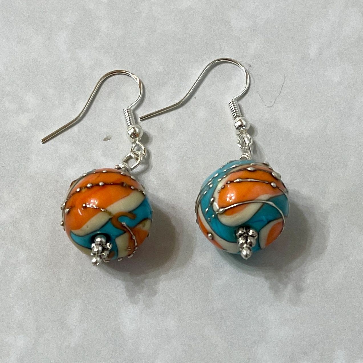 Orange and turquoise swirled bead earrings