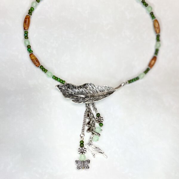 Feather pendant necklace with green beads
