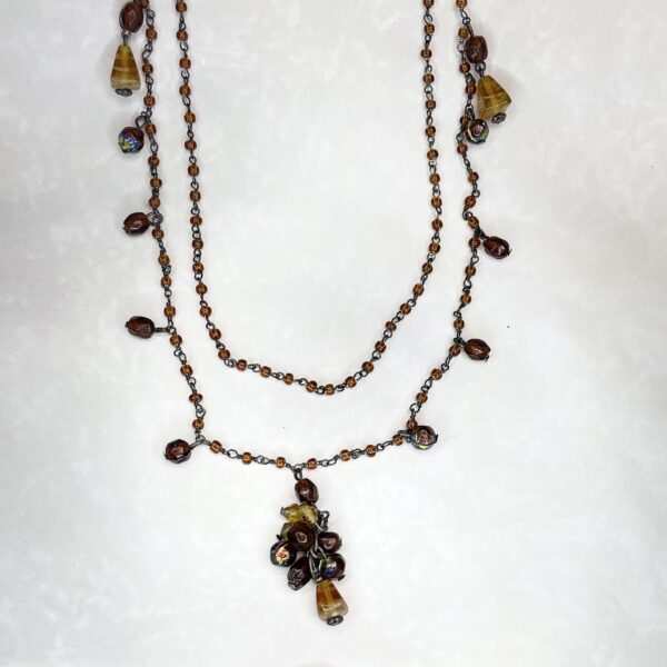 Layered brown beaded necklace with floral pendant