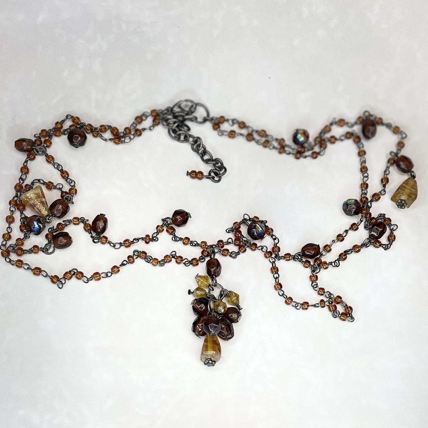 Multi-strand brown beaded necklace with pendant