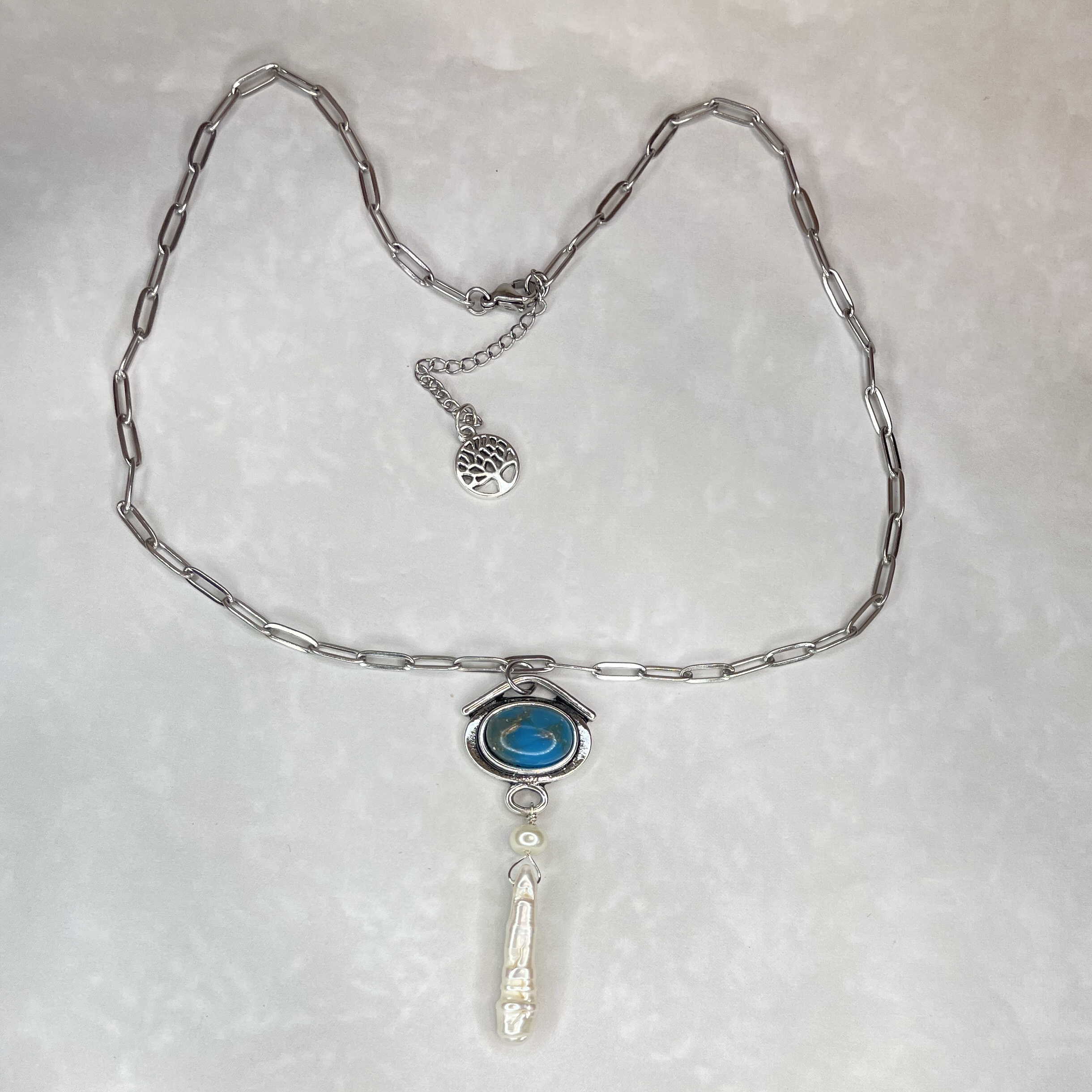 Silver necklace with blue pendant and pearl