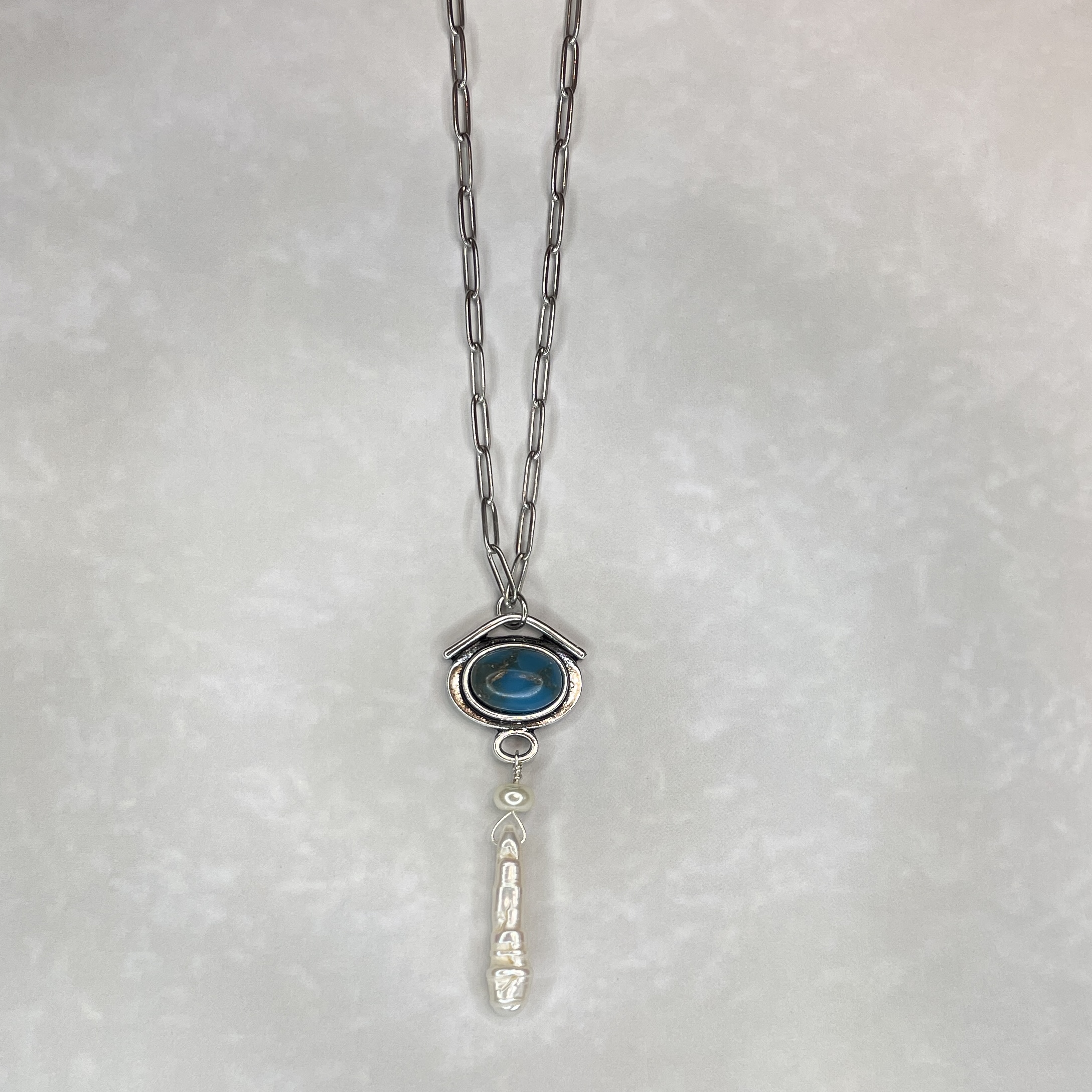 Silver necklace with blue oval stone pendant