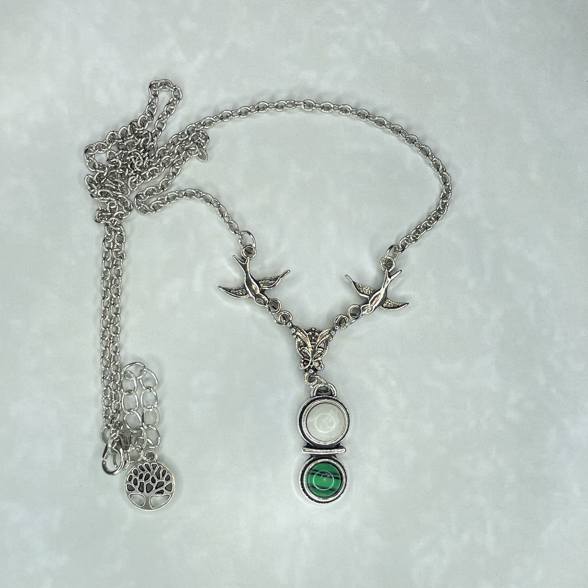 Silver bird necklace with white and green pendant
