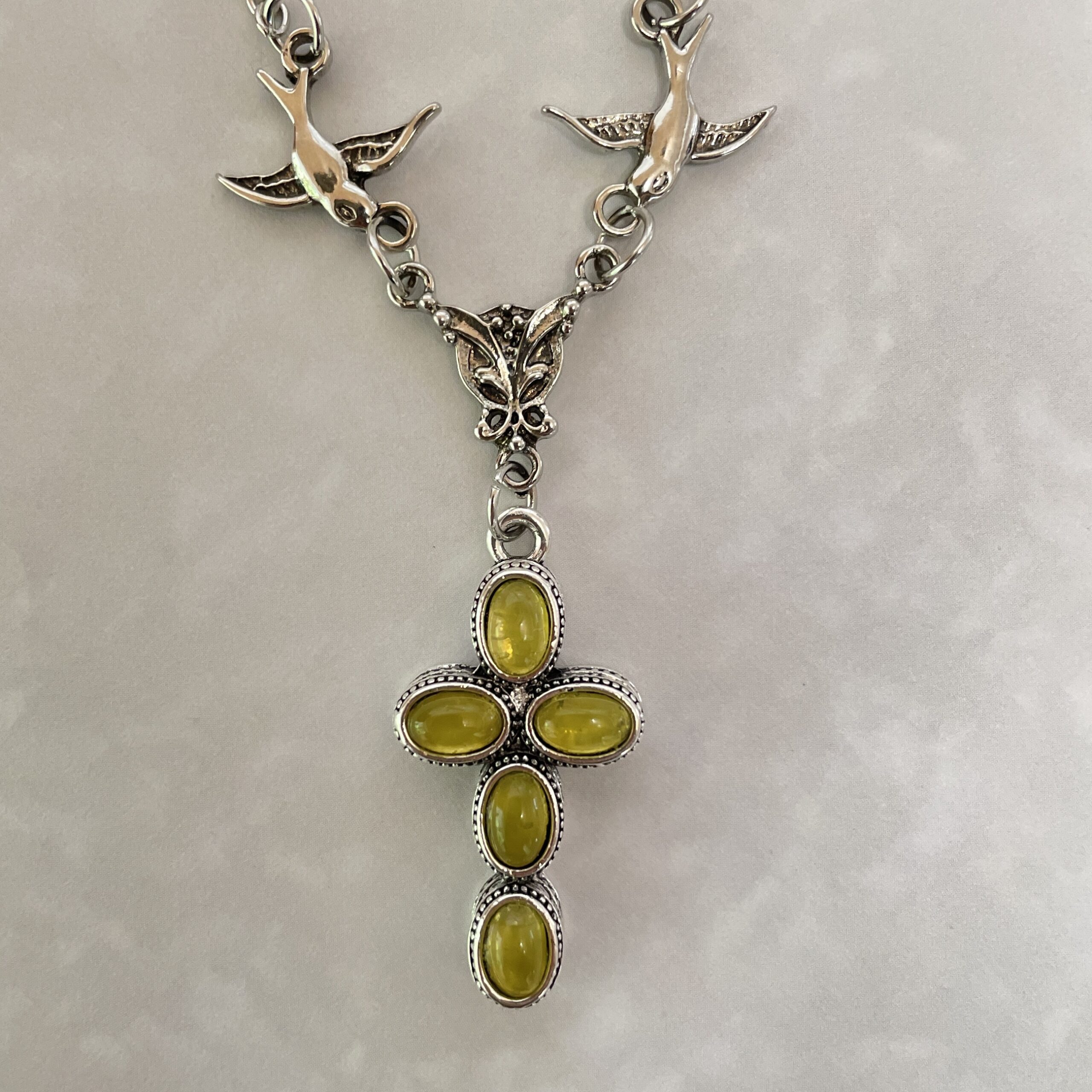 Silver cross pendant with yellow cabochon stones