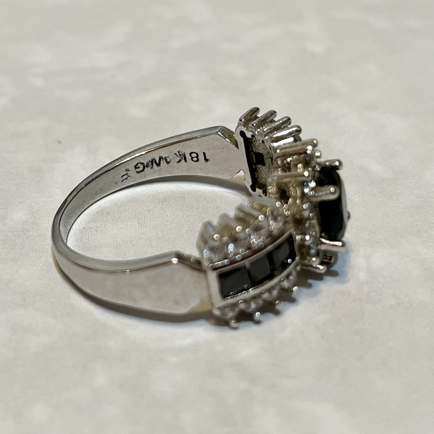 Elegant silver ring with black gemstone accents.