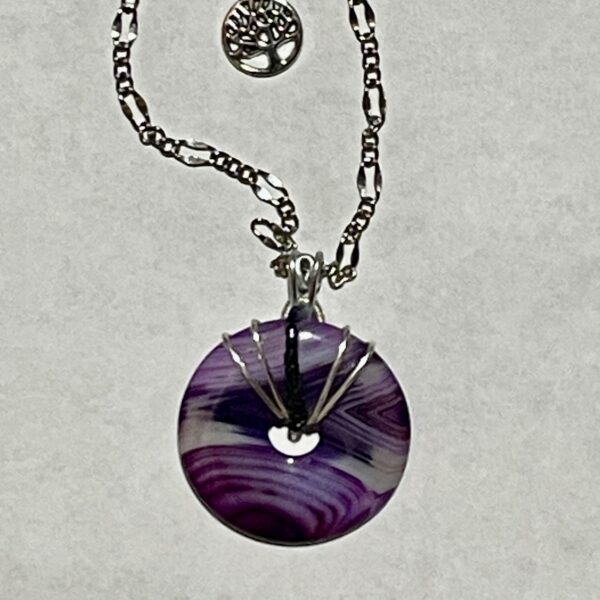 Wire-wrapped purple swirled donut pendant on chain