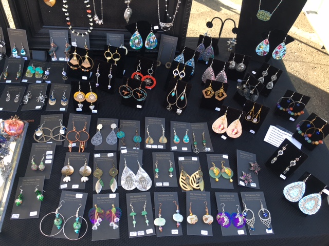 Display of colorful earrings on black table