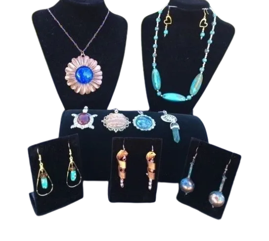 Assorted turquoise and silver jewelry on black stands