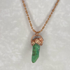 Green crystal pendant on gold chain