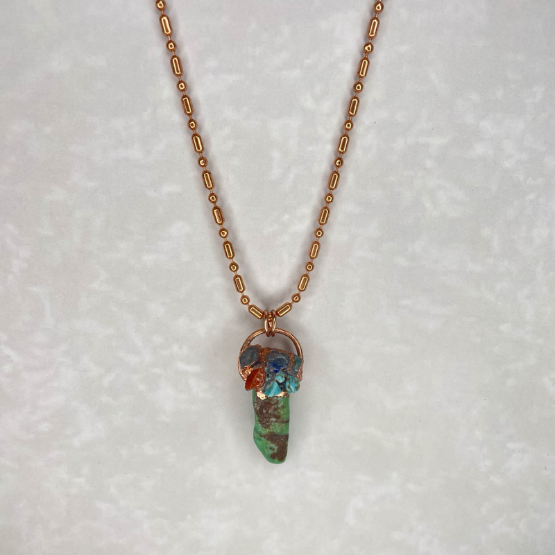 Wire-wrapped turquoise pendant on gold chain