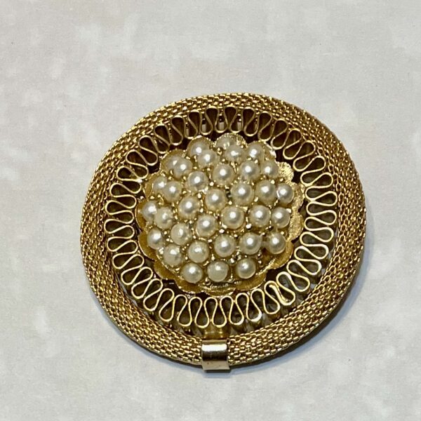 Gold brooch with clustered pearl design.