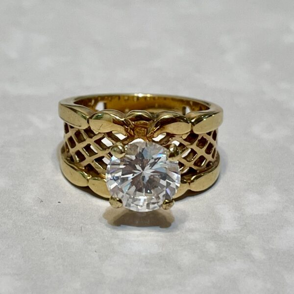 Gold ring with large round diamond.
