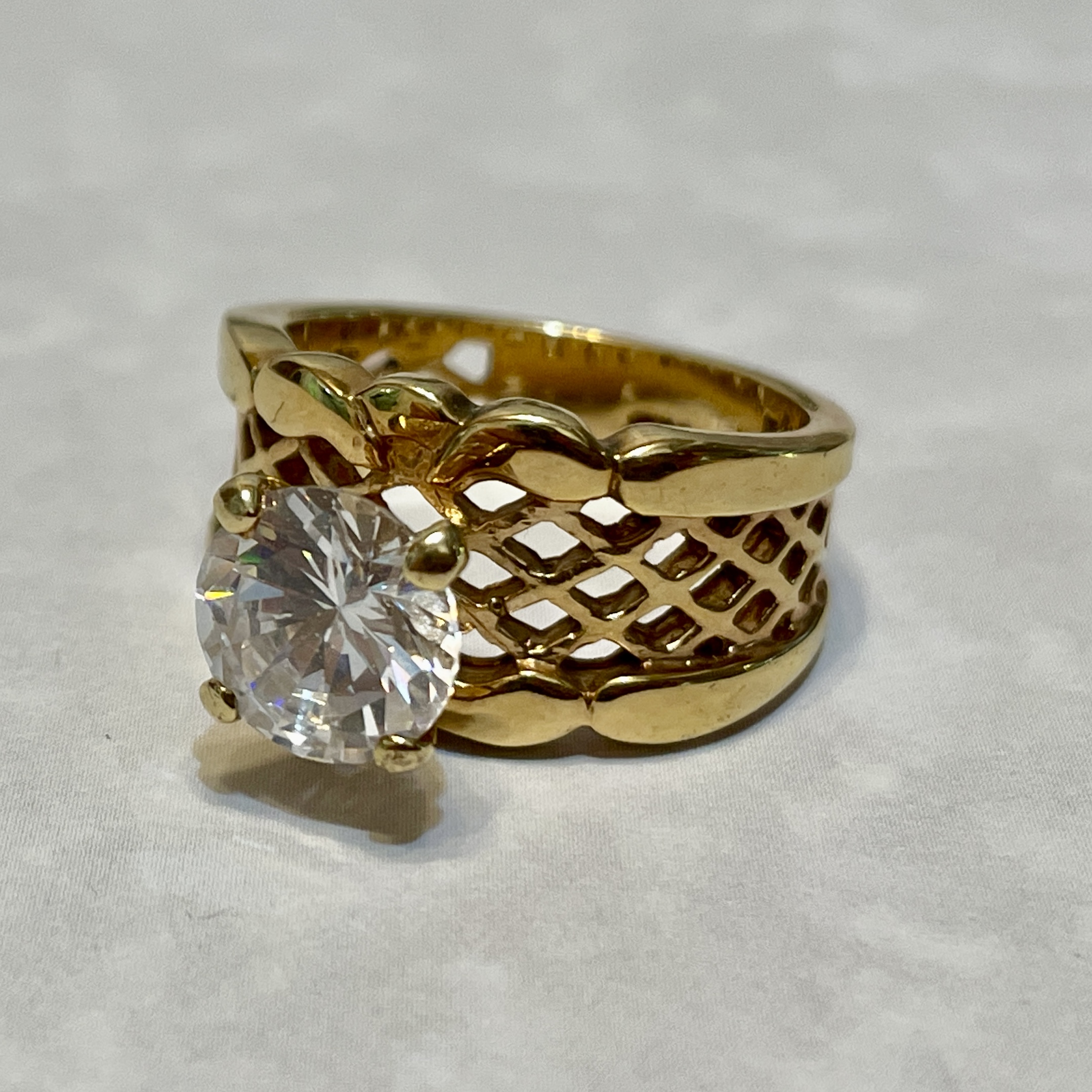 Elegant gold ring with a large gemstone.