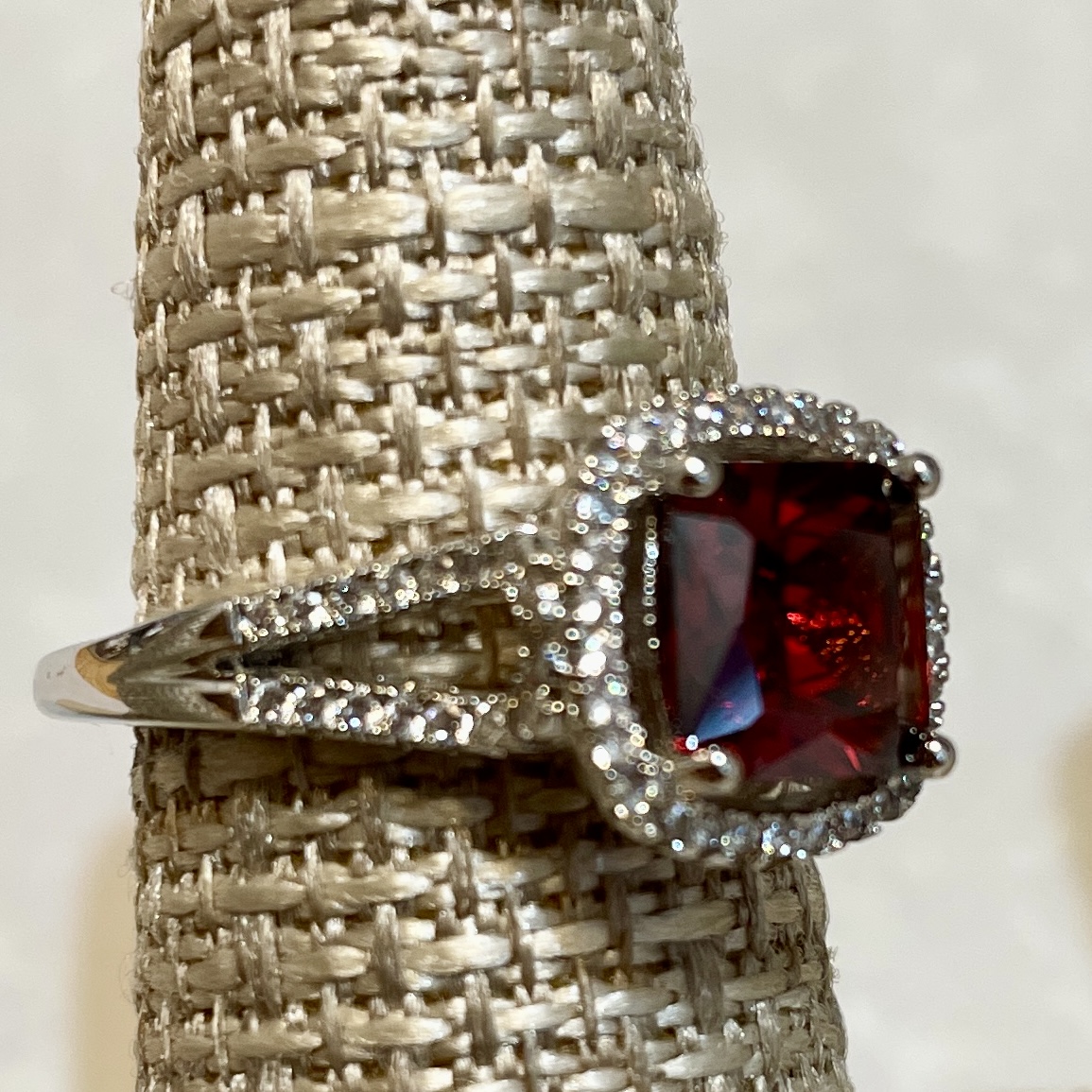 Elegant silver ring with large red gemstone.