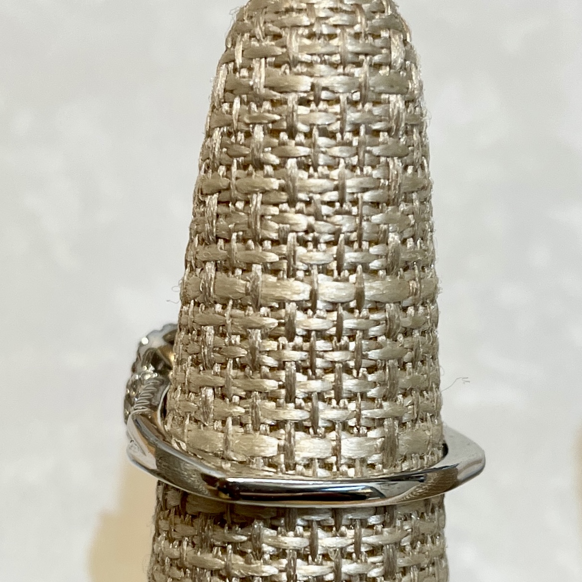 Sleek silver ring with intricate detailing.