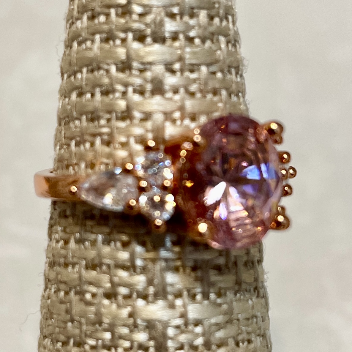 Elegant rose gold ring with pink gemstone centerpiece.