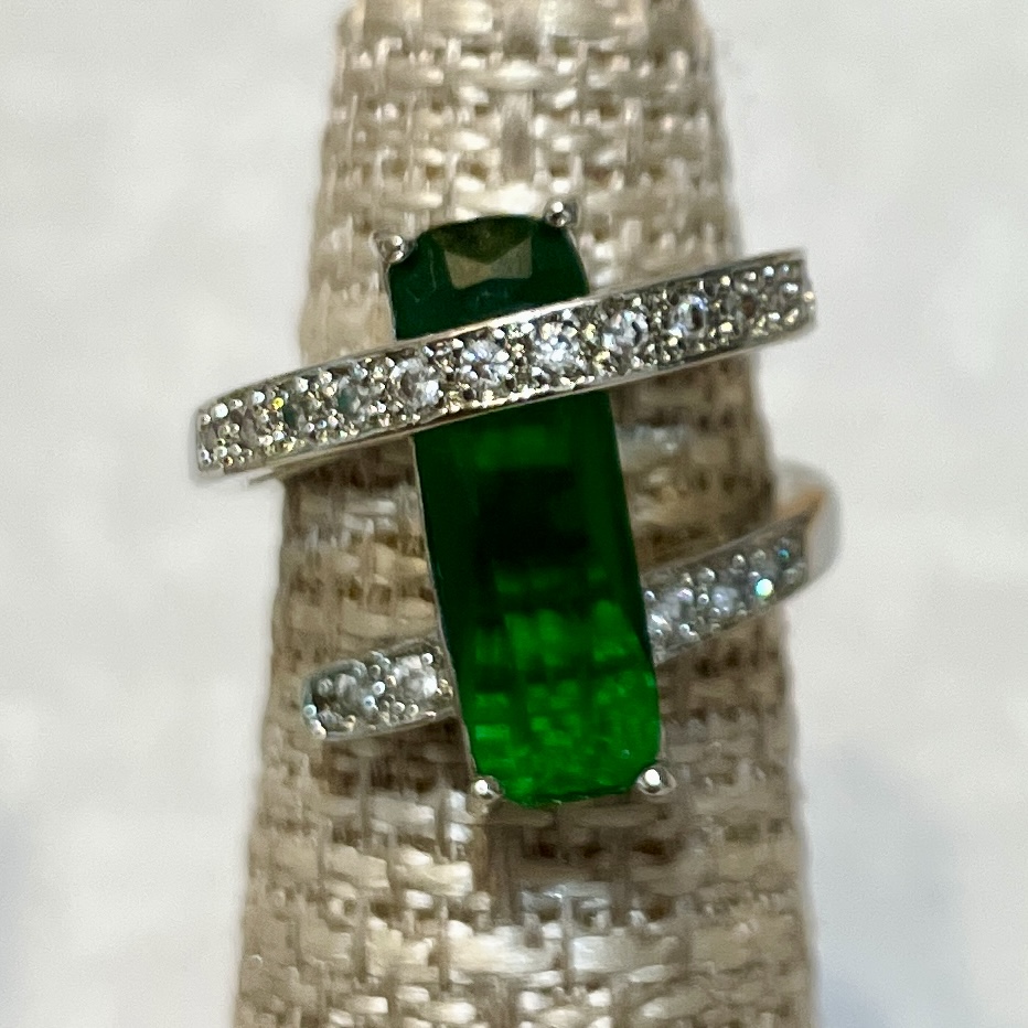 Elegant green gemstone ring with diamonds