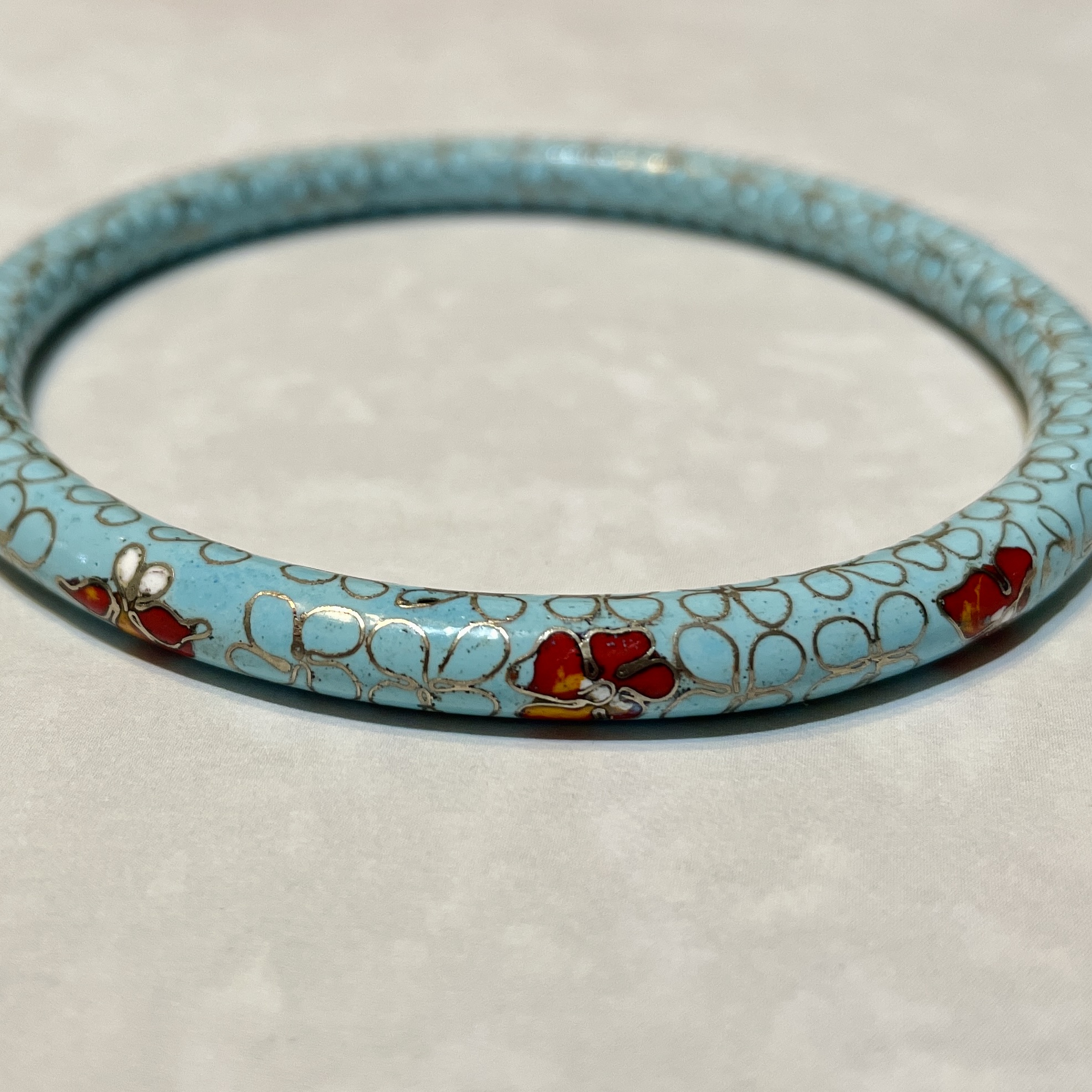 Charming blue bracelet featuring red blossoms