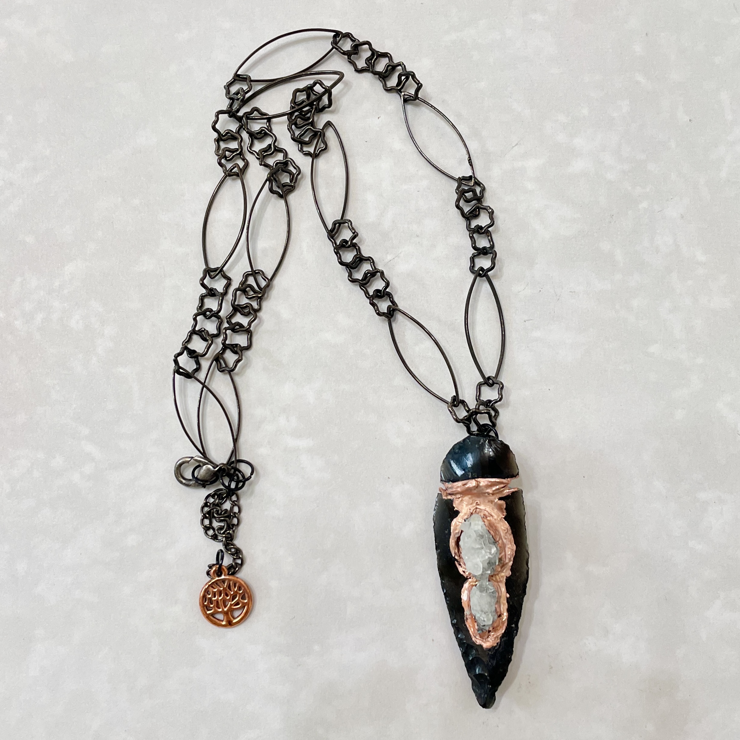 Black crystal pendant necklace with copper wrap