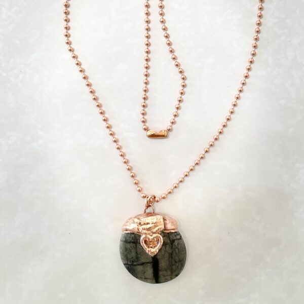 Rose gold necklace with round dark stone pendant
