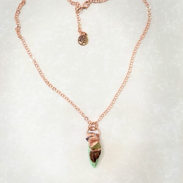 Rose gold necklace with green crystal pendant
